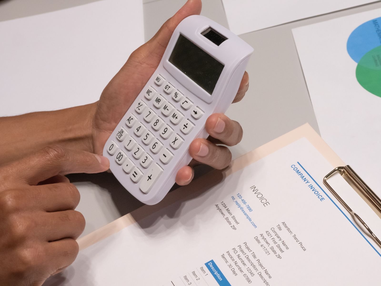 Calculator beside a printed company invoice