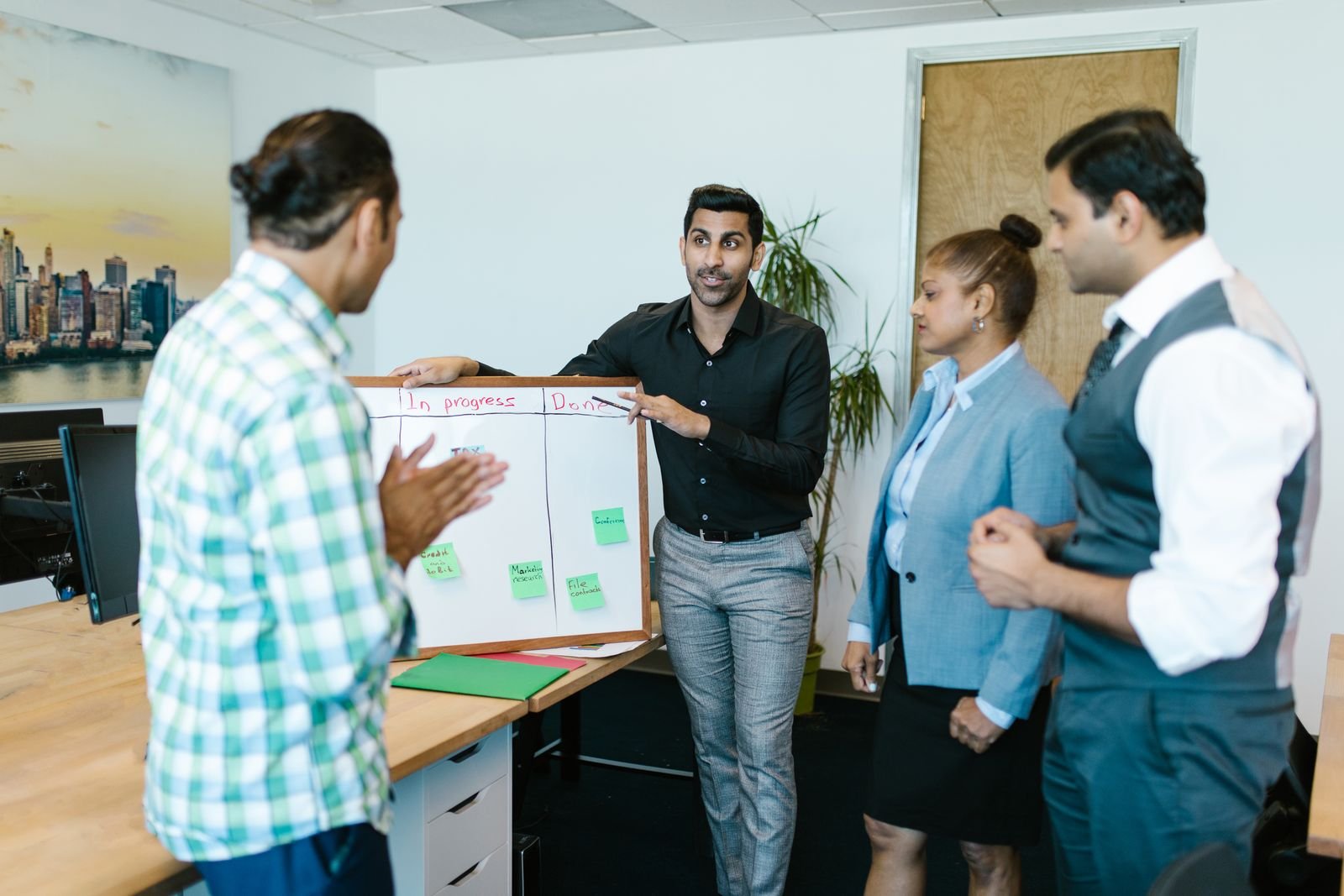 Team reviewing project progress on a whiteboard