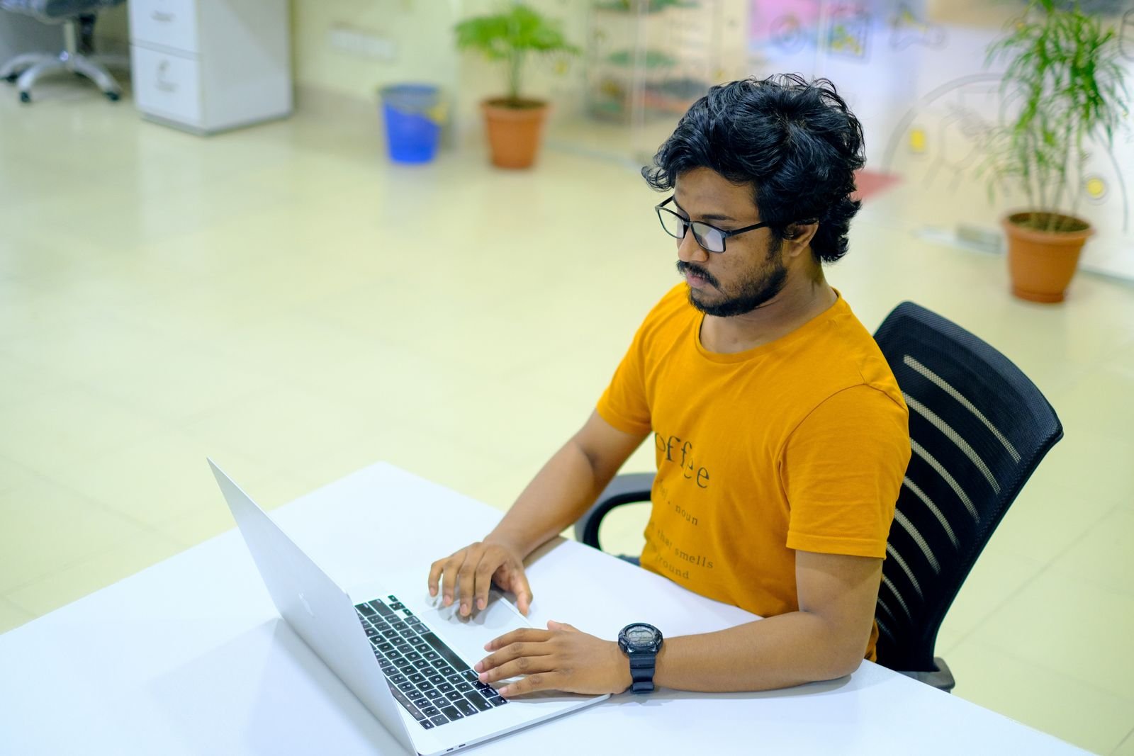 Developer working on a laptop in a bright office