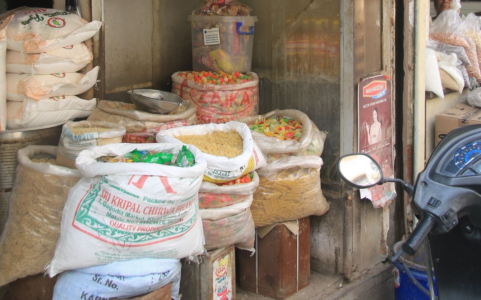 Grocery shop front with its signboard and goods on display