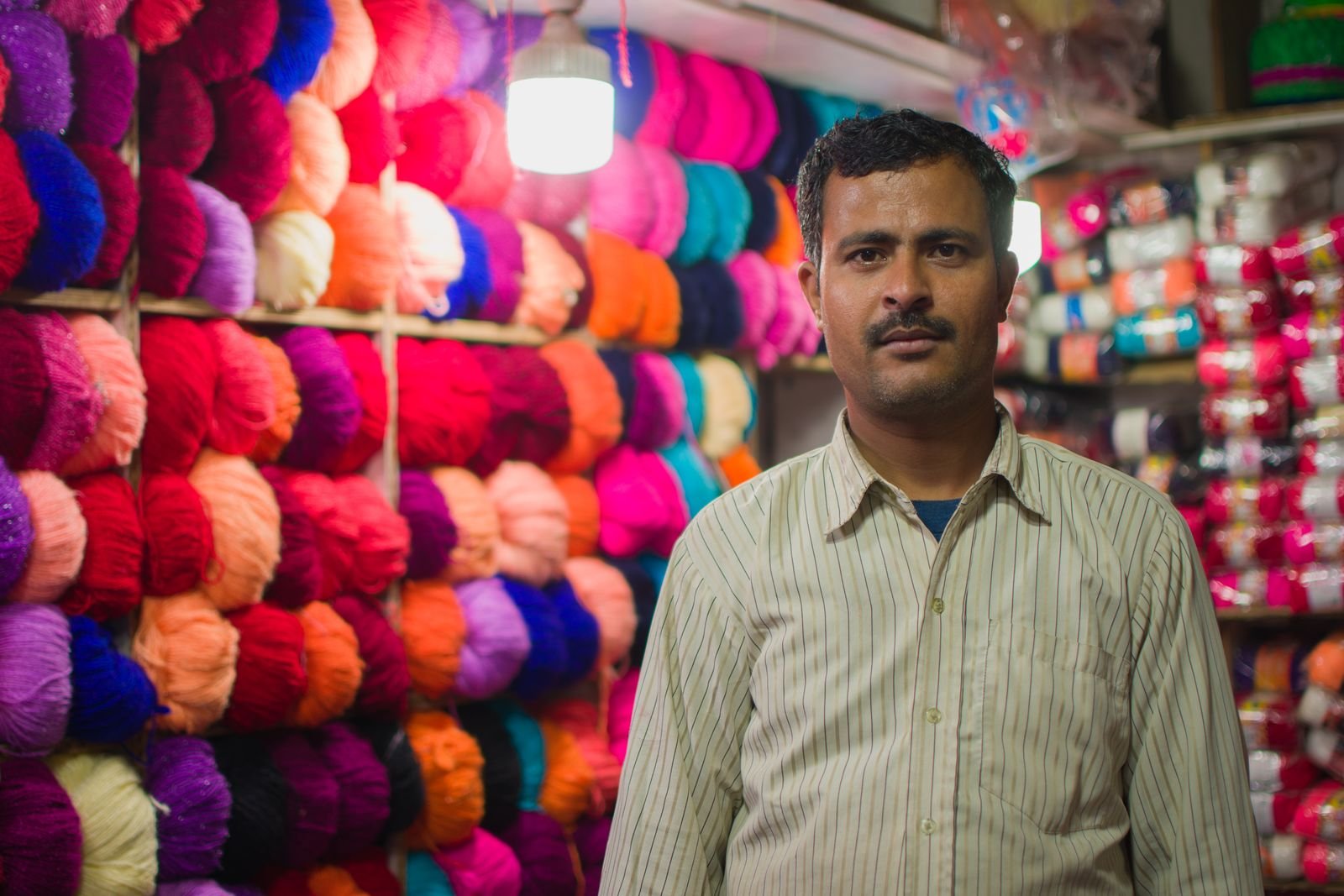 Trader standing at the counter of his wholesale shop