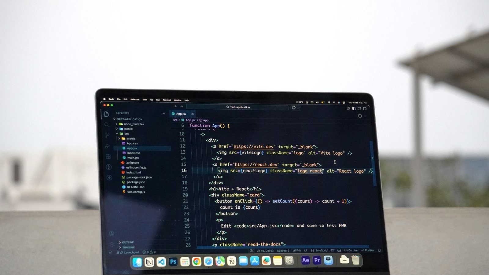 Laptop with website code open on a terrace in India
